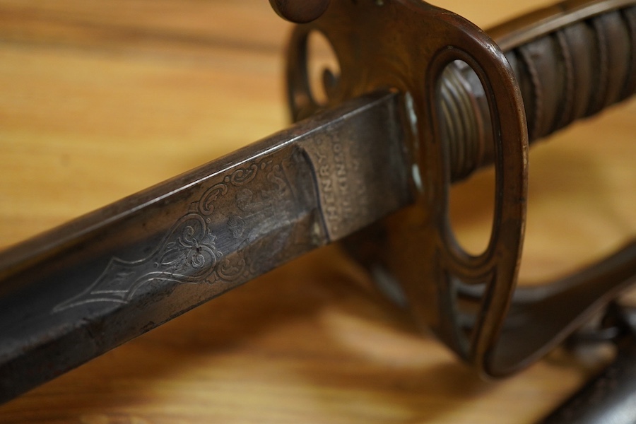 An 1845 pattern infantry officer’s sword by Henry Wilkinson, number 19387, regulation hilt, (fish skin covering missing), in its iron scabbard. Condition - fair to good.
